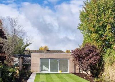 Newly installed lawn with garden landscaping and modern outbuilding in Wicklow